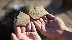 Fragmentos Cerámicos Antiguos en Manos de un Arqueólogo, Bien Cultural